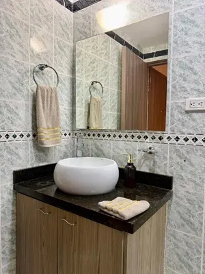 a bathroom with a sink and a mirror at Cozy Apartment Near Airport, Beaches & Old City in Cartagena de Indias