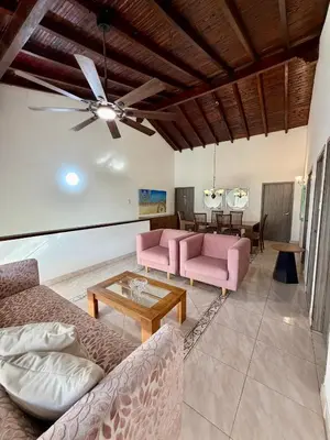 a living room with pink furniture and a ceiling fan at Cozy Apartment Near Airport, Beaches & Old City in Cartagena de Indias