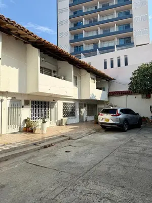 a car parked in a parking lot in front of a building at Cozy Apartment Near Airport, Beaches & Old City in Cartagena de Indias