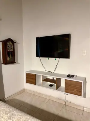 a flat screen tv on a white wall at Cozy Apartment Near Airport, Beaches & Old City in Cartagena de Indias