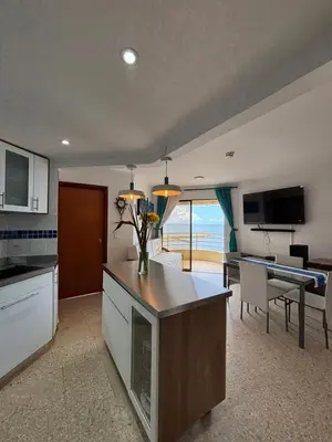 a kitchen and living room with a view of the ocean at Apartamento con la mejor ubicación y vista al mar in Cartagena de Indias