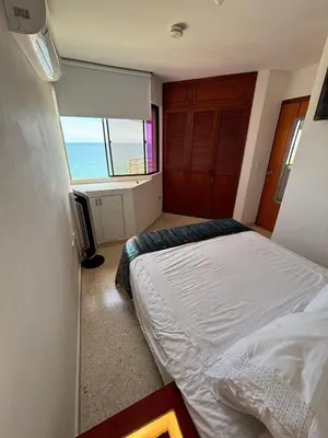 a bedroom with a bed and a view of the ocean at Apartamento con la mejor ubicación y vista al mar in Cartagena de Indias