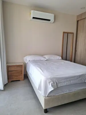 a bedroom with a bed and a air conditioner on the wall at Santa Marina Modern Loft Santa Marta in Santa Marta