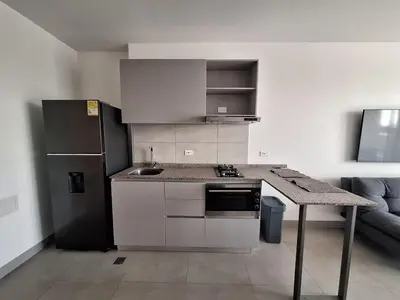 a kitchen with a counter top and a refrigerator at Santa Marina Modern Loft Santa Marta in Santa Marta