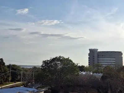 a building in the distance with trees and a sky at Santa Marina Modern Loft Santa Marta in Santa Marta