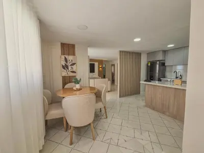 a kitchen and living room with a table and chairs at Margarita 93 in Barranquilla