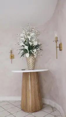 a vase of flowers on a table in a room at Margarita 93 in Barranquilla