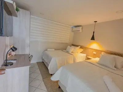 a hotel room with two beds in a room at Margarita 93 in Barranquilla