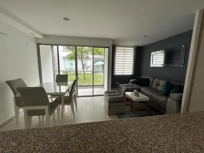a living room with a table and a couch and a dining room at Serena Del Mar Apartment in Cartagena de Indias