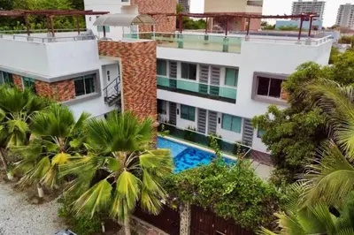 an aerial view of a building with a swimming pool at Vive el Lujo Caribeño - Mansión Premium con Piscina Privada y Vista al Mar in Santa Marta