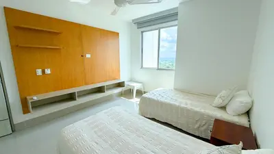 a bedroom with two beds and a large cabinet at Magico Apartamento Frente al Mar 5 Habitaciones OS121 in Coveñitas