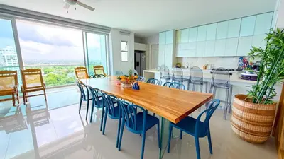a kitchen and dining room with a wooden table and chairs at Magico Apartamento Frente al Mar 5 Habitaciones OS121 in Coveñitas