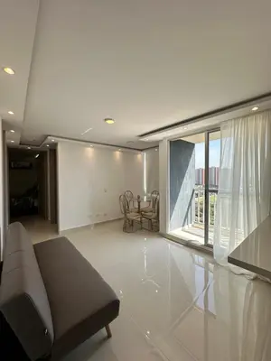 a living room with a couch and a large window at Apartamento a 5 min del cc Buena Vista in Barranquilla