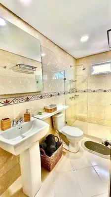a bathroom with a sink and a toilet and a mirror at Vive Cartagena frente al mar y el lago in Cartagena de Indias