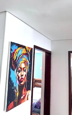 a painting of a woman on a wall next to a mirror at Vive Cartagena magica frente al mar y lago in Cartagena de Indias