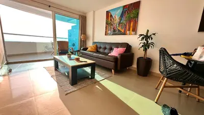a living room with a couch and a table at Vive Cartagena magica frente al mar y lago in Cartagena de Indias
