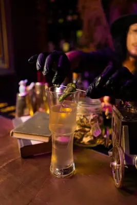 a person is stirring a drink in a glass at Cuna 58 in Barranquilla