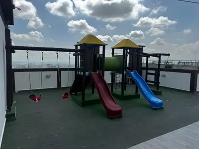 a playground with slides and swings on a roof at NEW Premium 1BR Apartment in the Best Area in Barranquilla