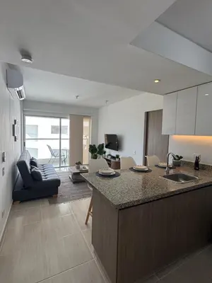 a kitchen and living room with a sink and a couch at Apartamento Serena del mar Trevi in Cartagena de Indias