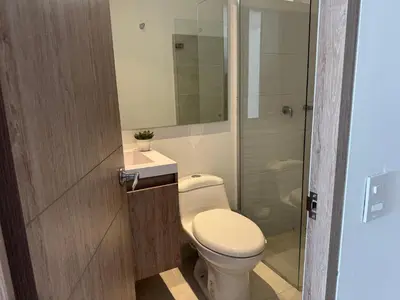 a bathroom with a toilet and a sink and a shower at Apartamento Serena del mar Trevi in Cartagena de Indias