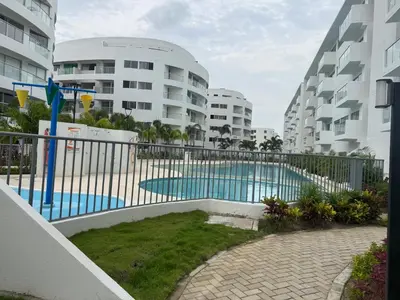 a fence around a swimming pool in a apartment complex at Apartamento Serena del mar Trevi in Cartagena de Indias