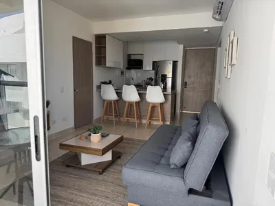 a living room with a couch and a table at Apartamento Serena del mar Trevi in Cartagena de Indias