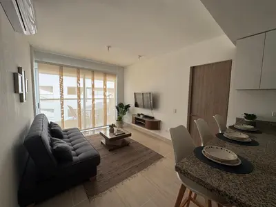 a living room with a couch and a table at Apartamento Serena del mar Trevi in Cartagena de Indias