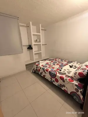 a bedroom with a bed and a chalkboard at Apartamento acogedor y fresco cerca al norte de barranquilla in Barranquilla