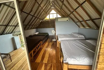 a room with two beds in a house at Casaroca in Turbaco