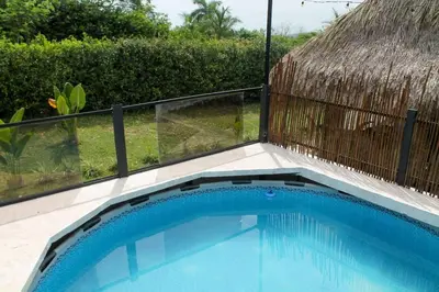 a swimming pool with a fence around it at Casaroca in Turbaco