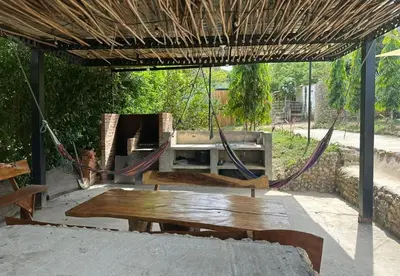 a hammock in a pavilion with a bench and a table at Casaroca in Turbaco