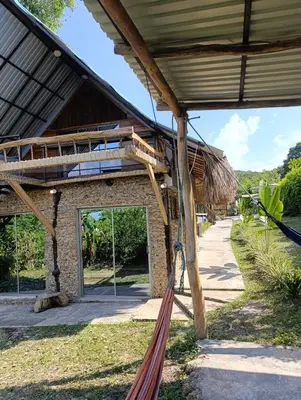 a hammock on the side of a building at Casaroca in Turbaco
