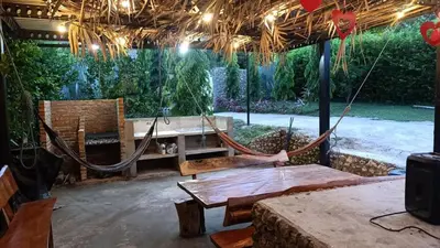 a patio with a hammock and a table and chairs at Casaroca in Turbaco