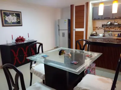 a kitchen with a table and chairs and a refrigerator at Ideal house for Carnival in Barranquilla