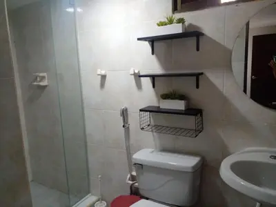a bathroom with a toilet and a shower and a sink at Ideal house for Carnival in Barranquilla
