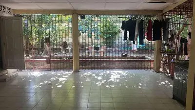 a room with a window with clothes on racks at Habitacion con baño en zona de carnaval in Barranquilla