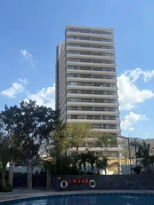 a tall building with a pool in front of it at Cardona Suite Santa Marina Santa Marta in Santa Marta