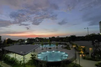 a large swimming pool in a park at night at Cardona Suite Santa Marina Santa Marta in Santa Marta
