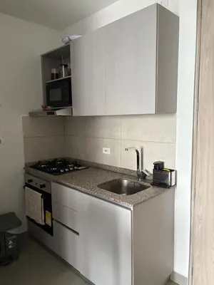 a kitchen with a sink and a stove at Cardona Suite Santa Marina Santa Marta in Santa Marta