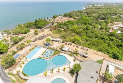 an aerial view of a resort with a swimming pool at Cardona Suite Santa Marina Santa Marta in Santa Marta