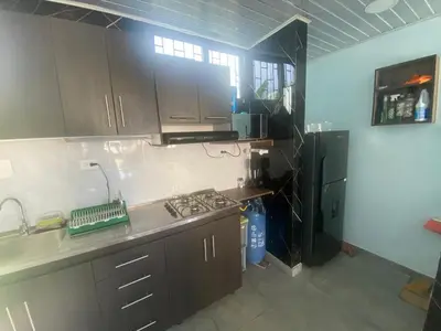 a kitchen with a stove and a refrigerator at El Castillo in Moñitos