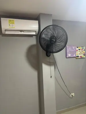 a fan is attached to the corner of a room at Gisela Wax More Guess Room in Cartagena de Indias