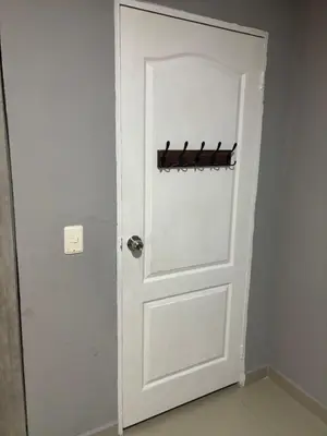 a white door with a hanger behind it at Gisela Wax More Guess Room in Cartagena de Indias