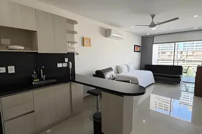 a kitchen and living room with a couch and a bed at Hermoso Apto de 1 hab con Vista al Mar - Piso 10 in Cartagena de Indias