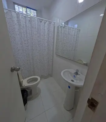 a bathroom with a toilet and a sink and a mirror at Hostel Casa Kanaloa Isla de Baru in Ararca