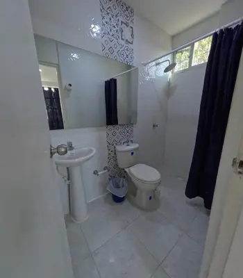 a bathroom with a toilet and a sink at Hostel Casa Kanaloa Isla de Baru in Ararca