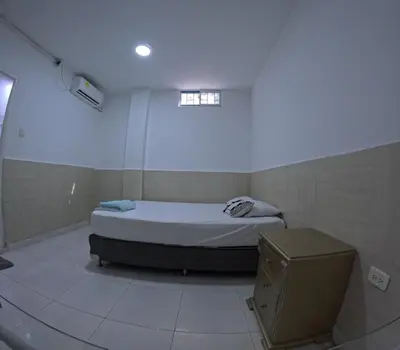 a small bedroom with a bed and a window at Hostel Casa Kanaloa Isla de Baru in Ararca