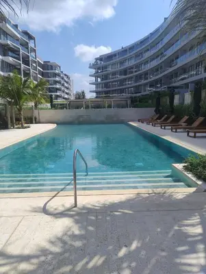 a large swimming pool with benches in front of a building at Manzanillo Loft Morros EOS in Cartagena de Indias