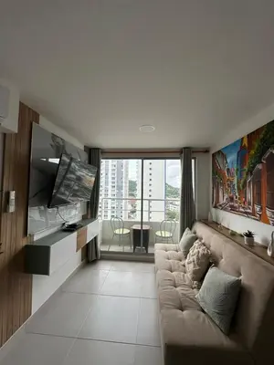 a living room with a couch and a flat screen tv at Caribbean Deluxe Apartment Walk to Beach WiFi in Cartagena de Indias