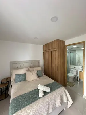 a bedroom with a large bed with towels on it at Caribbean Deluxe Apartment Walk to Beach WiFi in Cartagena de Indias